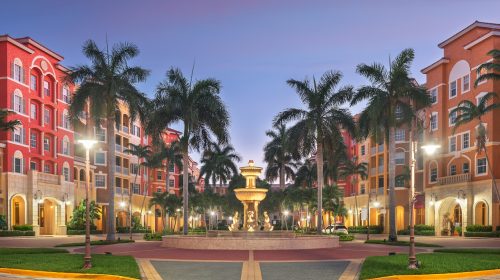 Naples, Florida, USA town skyline and city plaza at twilight.